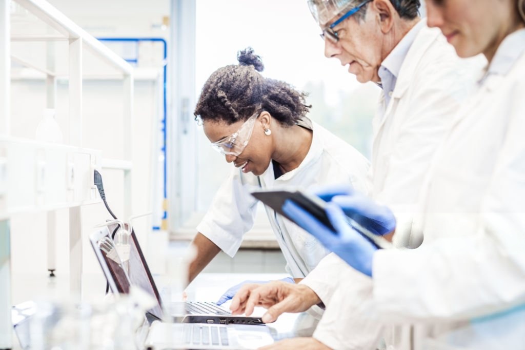Scientists working at a computer in a biotechnology laboratory